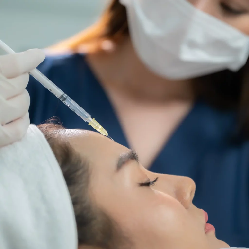 Dermatology at Sendlinger Tor Botox young asian woman making cosmetology treatment